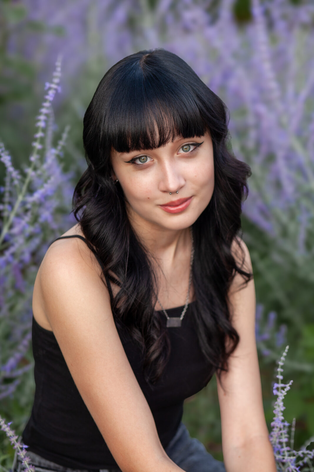 Headshot of Charleigh Huenink smiling in front of a flower field