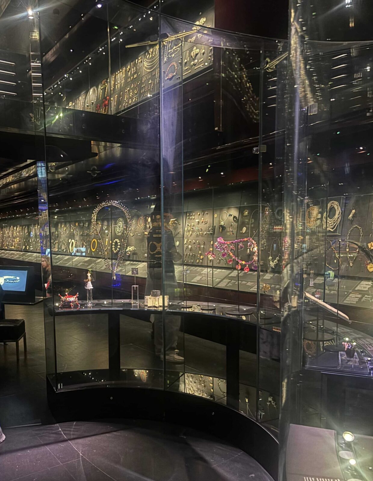 A room filled with jewelry in large glass cases in a museum