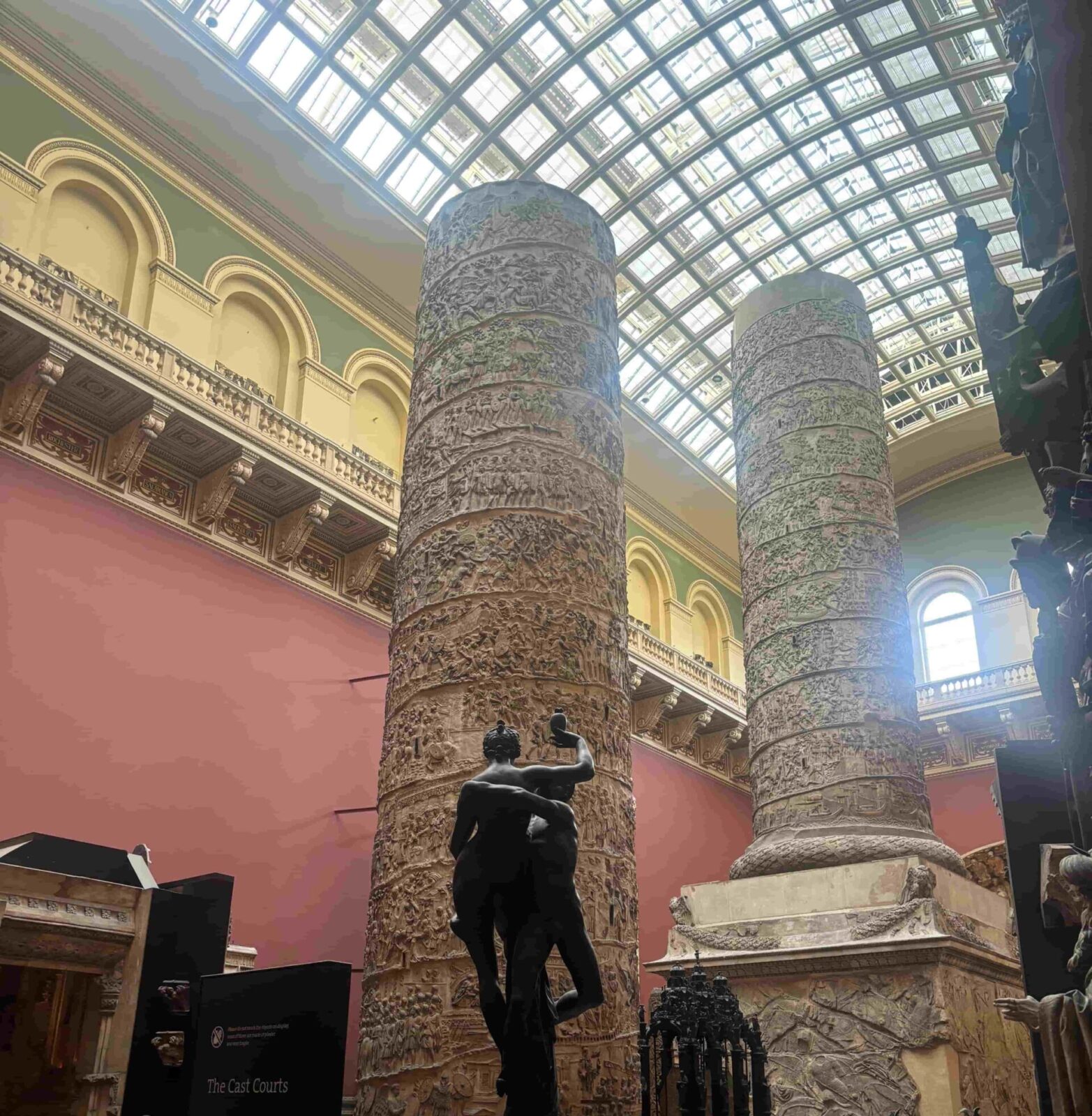 Cast replicas of Trajan's columns in a large open room of a museum