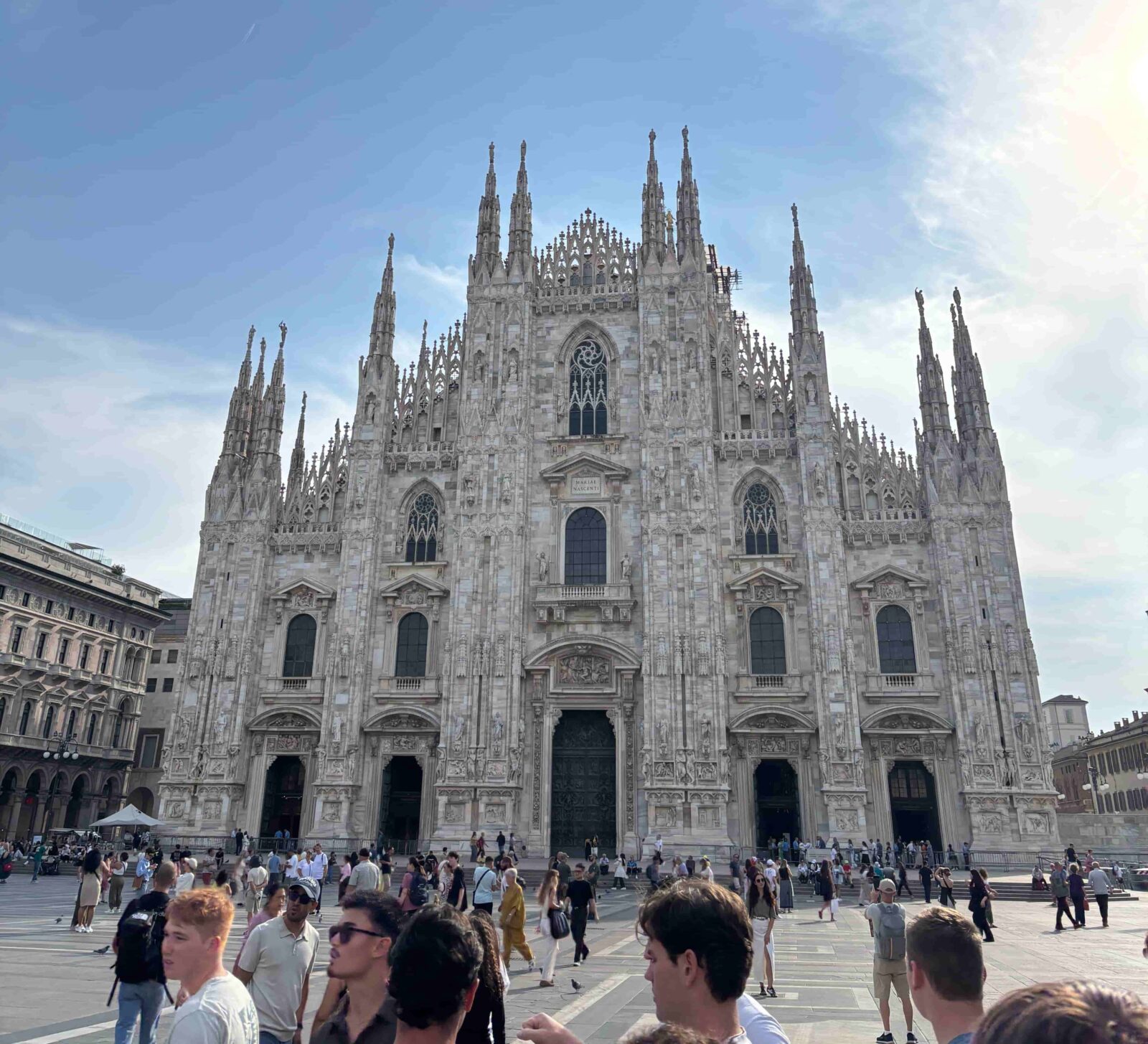 A large Cathedral with people walking in front of it.